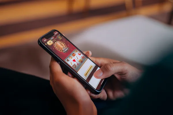 A cheerful woman in traditional clothing using her smartphone during a festive moment, showing how easily the BEFFURY app fits into everyday life.