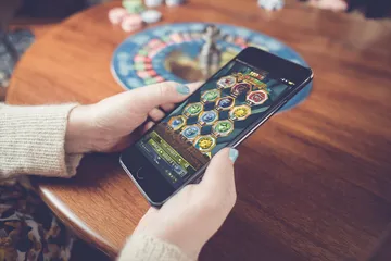 A stylish woman beside vibrant slot machines displaying glowing sevens, showcasing the variety of top slots at BEFFURY.