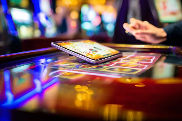 A person using their device against a moody casino-themed background, illustrating the smooth re-entry process at BEFFURY.